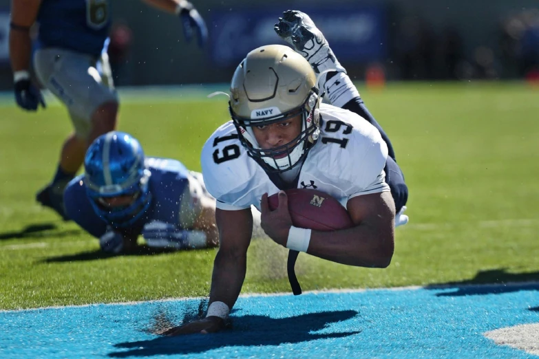 a football player dives to catch a ball, a digital rendering, unsplash, happening, navy, soyjack, brown, nice weather