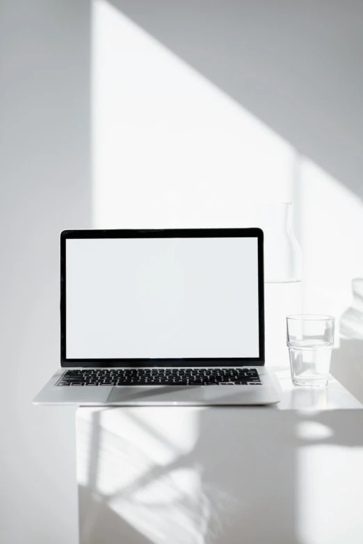 a laptop computer sitting on top of a white desk, pexels, clean and empty, my computer icon, backlighted, clean aesthetic