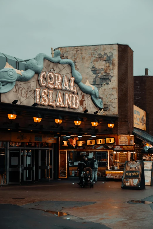 a building with a sign that says coral island, inspired by Elsa Bleda, pexels contest winner, magical realism, food stalls, vintage movie, gotham, 2 0 2 2 photo