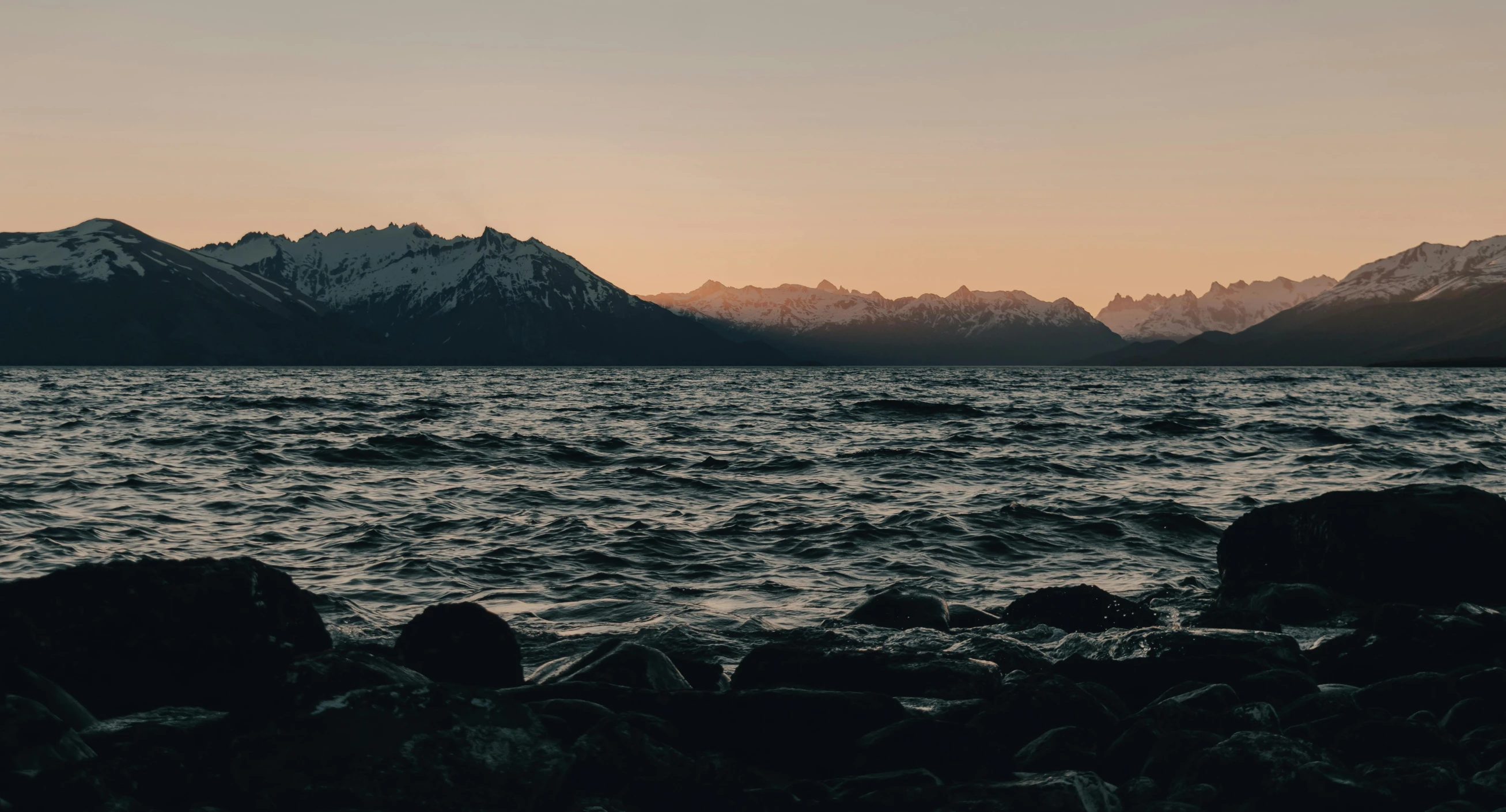 a body of water with mountains in the background, an album cover, unsplash contest winner, early evening, shoreline, hq 4k phone wallpaper, alaska