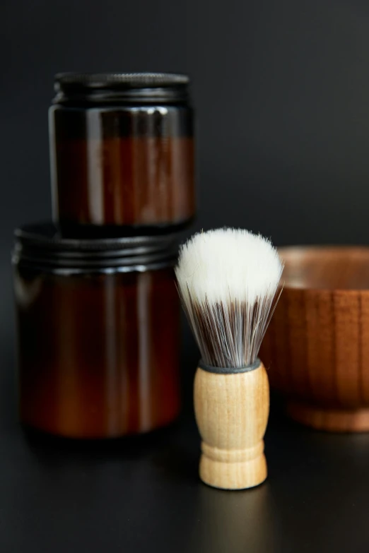 a shaving brush sitting next to a wooden bowl, a portrait, unsplash, bottles covered in wax, thumbnail, close - up studio photo, bald