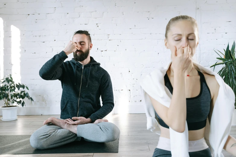 a man and a woman doing yoga together, pexels contest winner, hand over mouth, speak no evil, smoking with squat down pose, sleepy