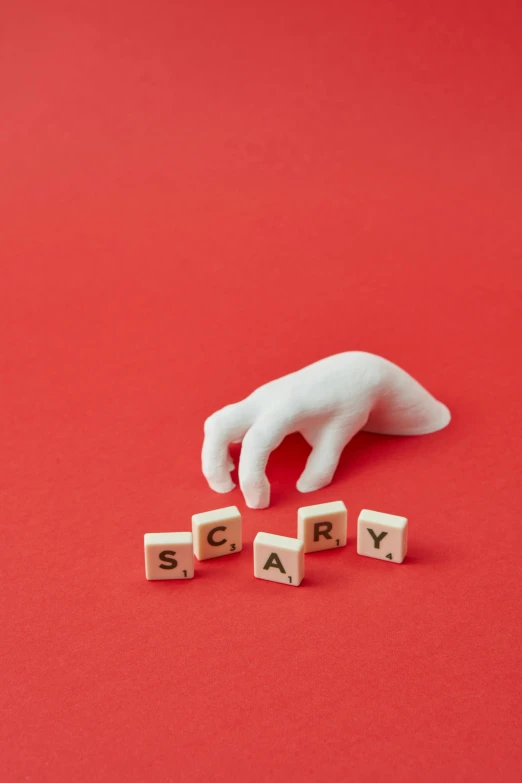 the word sorry spelled with scrabbles on a red background, an album cover, by artist, pexels contest winner, magic realism, horror spooky, hand model, porcelain sculpture, cryptid