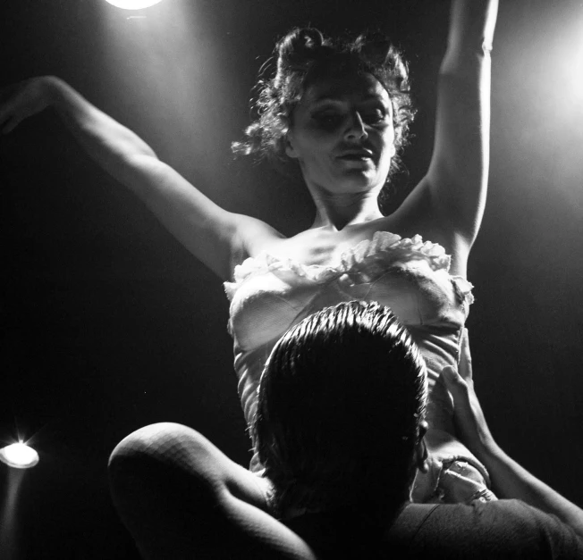 a black and white photo of a woman in a dress, by Matthijs Naiveu, flickr, figuration libre, burlesque psychobilly, concert, lit from bottom, olga kurylenko