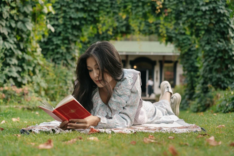 a woman laying on a blanket reading a book, by Alice Mason, pexels contest winner, parks and gardens, ivy, sydney park, embroidered robes