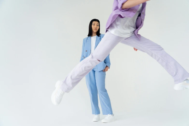 a woman standing next to a man in a suit, inspired by Russell Dongjun Lu, trending on pexels, standing on two legs, lilac, pale blue outfit, jumping at the viewer