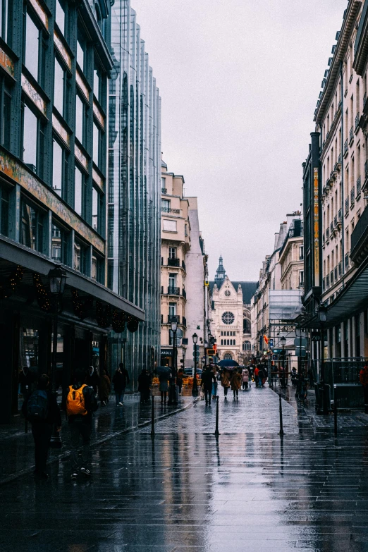 a city street filled with lots of tall buildings, by Raphaël Collin, pexels contest winner, art nouveau, just after rain, casually dressed, square, normandy