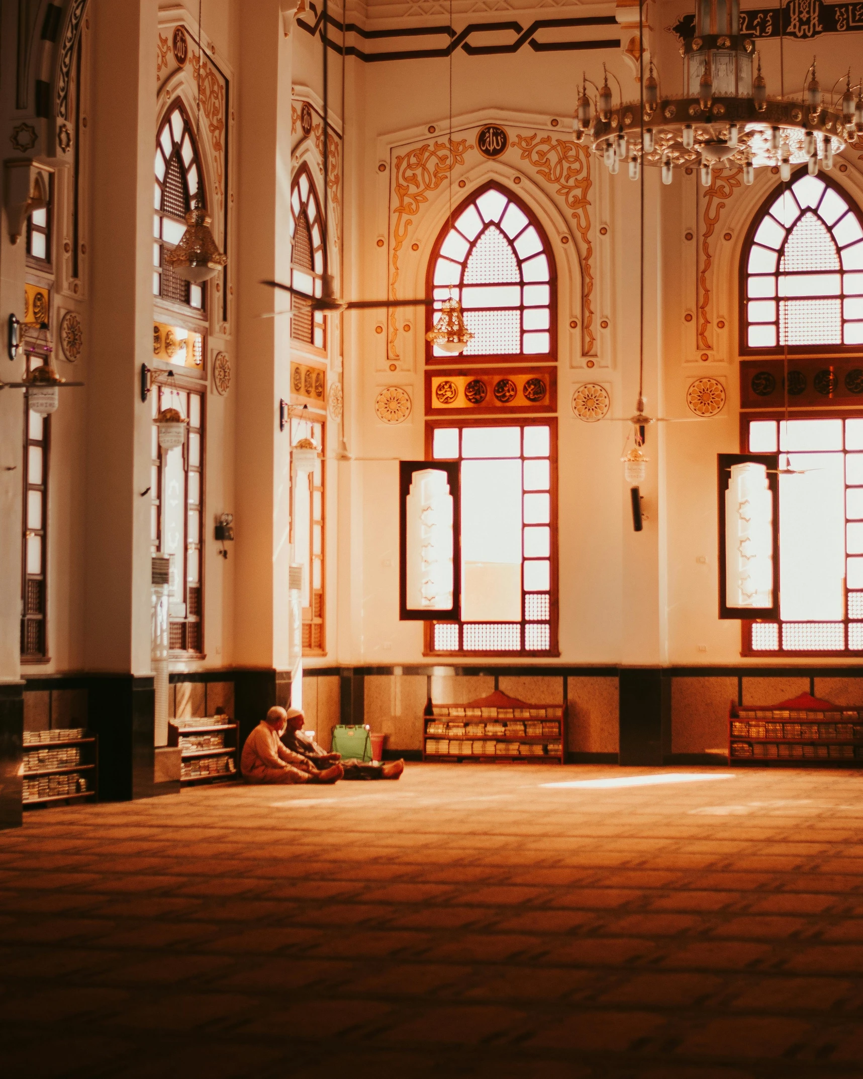 a person sitting on the floor in a large room, by Julia Pishtar, unsplash contest winner, hurufiyya, mosque synagogue interior, tall windows lit up, thumbnail, indonesia