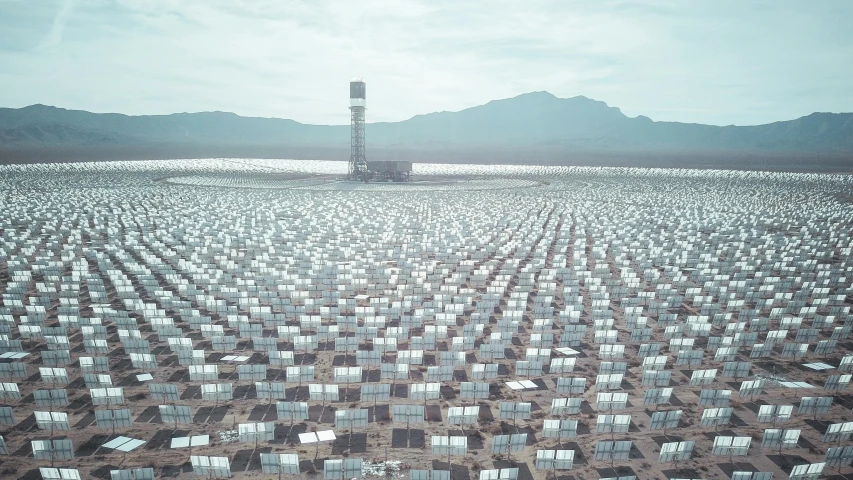 a large solar array in a desert with mountains in the background, a colorized photo, by Andreas Gursky, unsplash contest winner, tall metal towers, desert white greenhouse, o'neill cylinder colony, searchlights in background