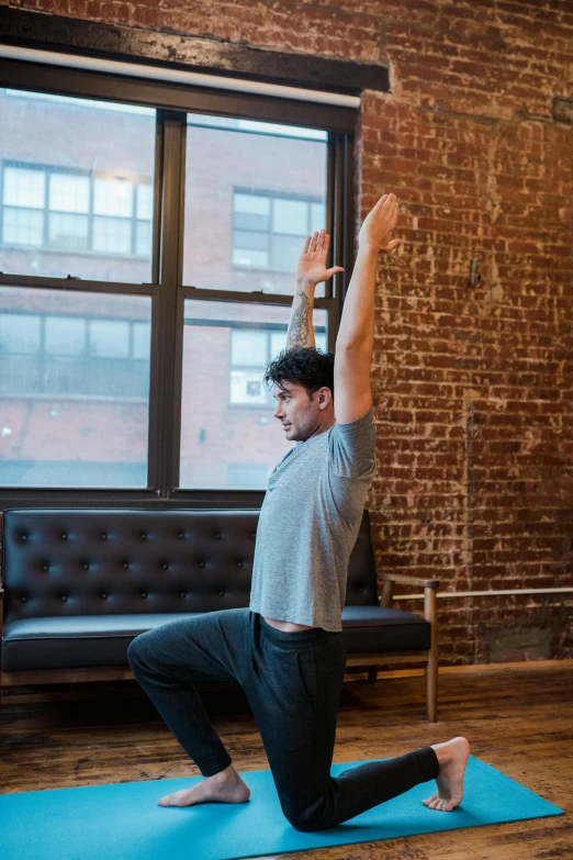 a man doing a yoga pose in front of a window, by Carey Morris, mid action swing, square, medium shot angle, back