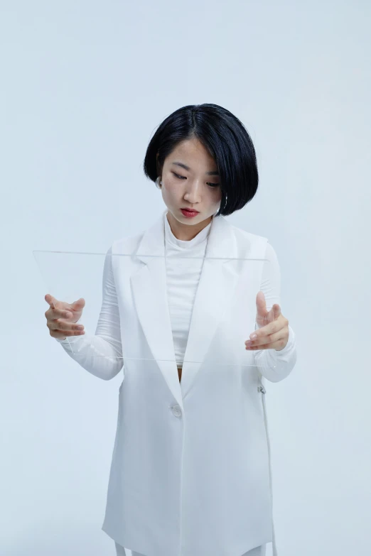 a woman in a white suit holding a glass of water, an album cover, inspired by Fei Danxu, unsplash, wearing translucent sheet, technologies, with a bob cut, coat pleats