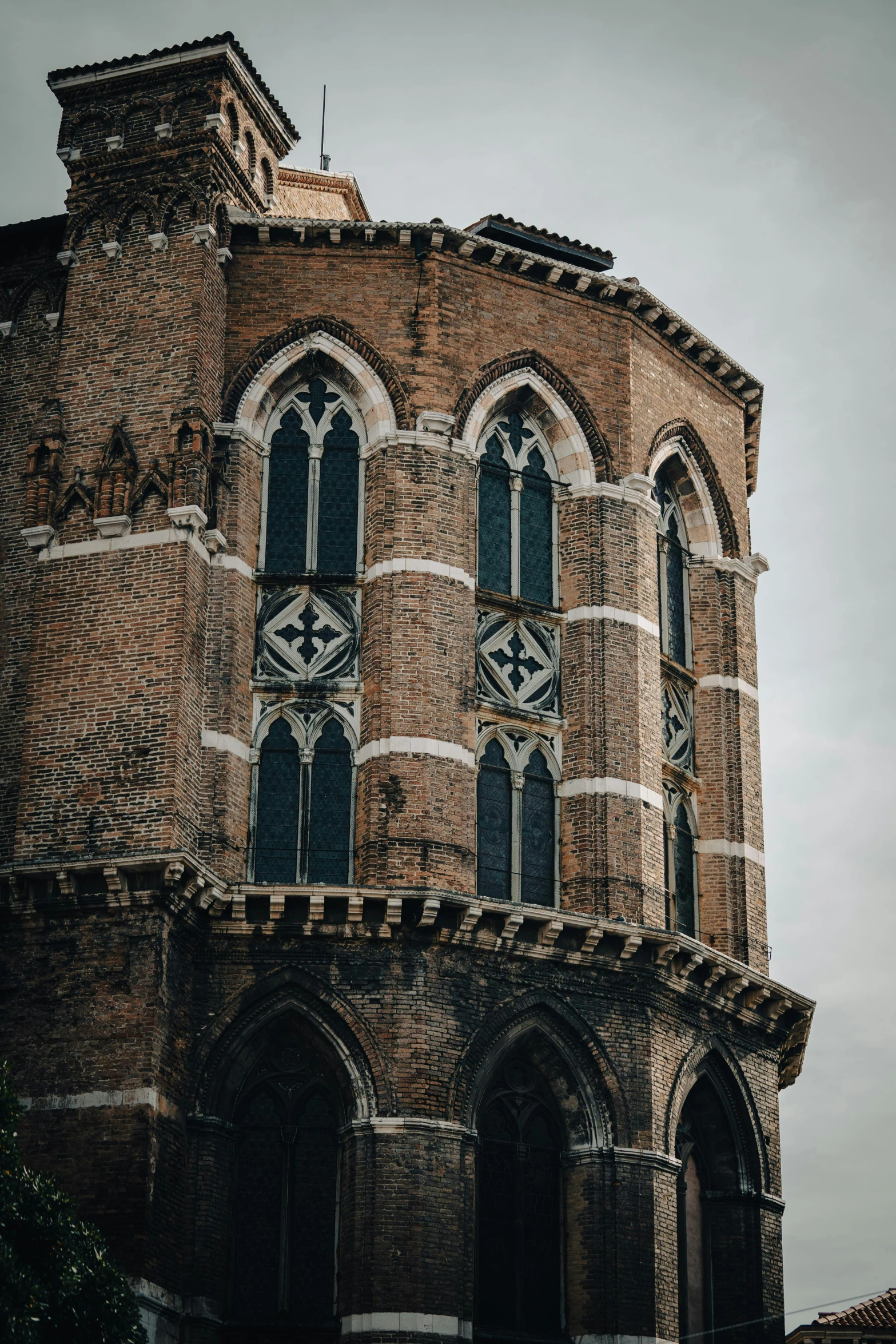 a tall brick building with a clock tower, by Jan Tengnagel, pexels contest winner, romanesque, moody details, intricate venetian patterns, church window, buttresses