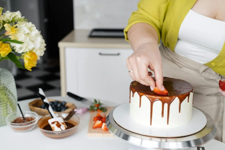 a woman is decorating a cake with chocolate and strawberries, pexels contest winner, hurufiyya, pristine and clean design, caramel, profile image, melbourne