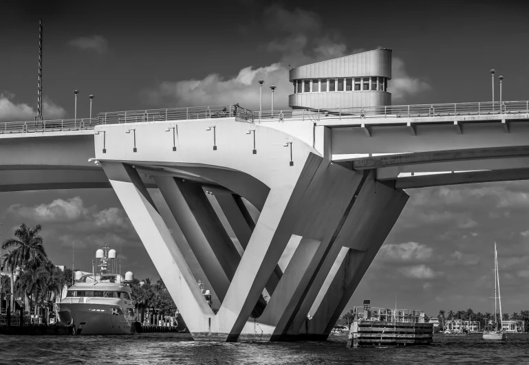 a black and white photo of a bridge over a body of water, by Dave Melvin, hypermodernism, shaped like a yacht, under repairs, portrait of a big, googie architecture