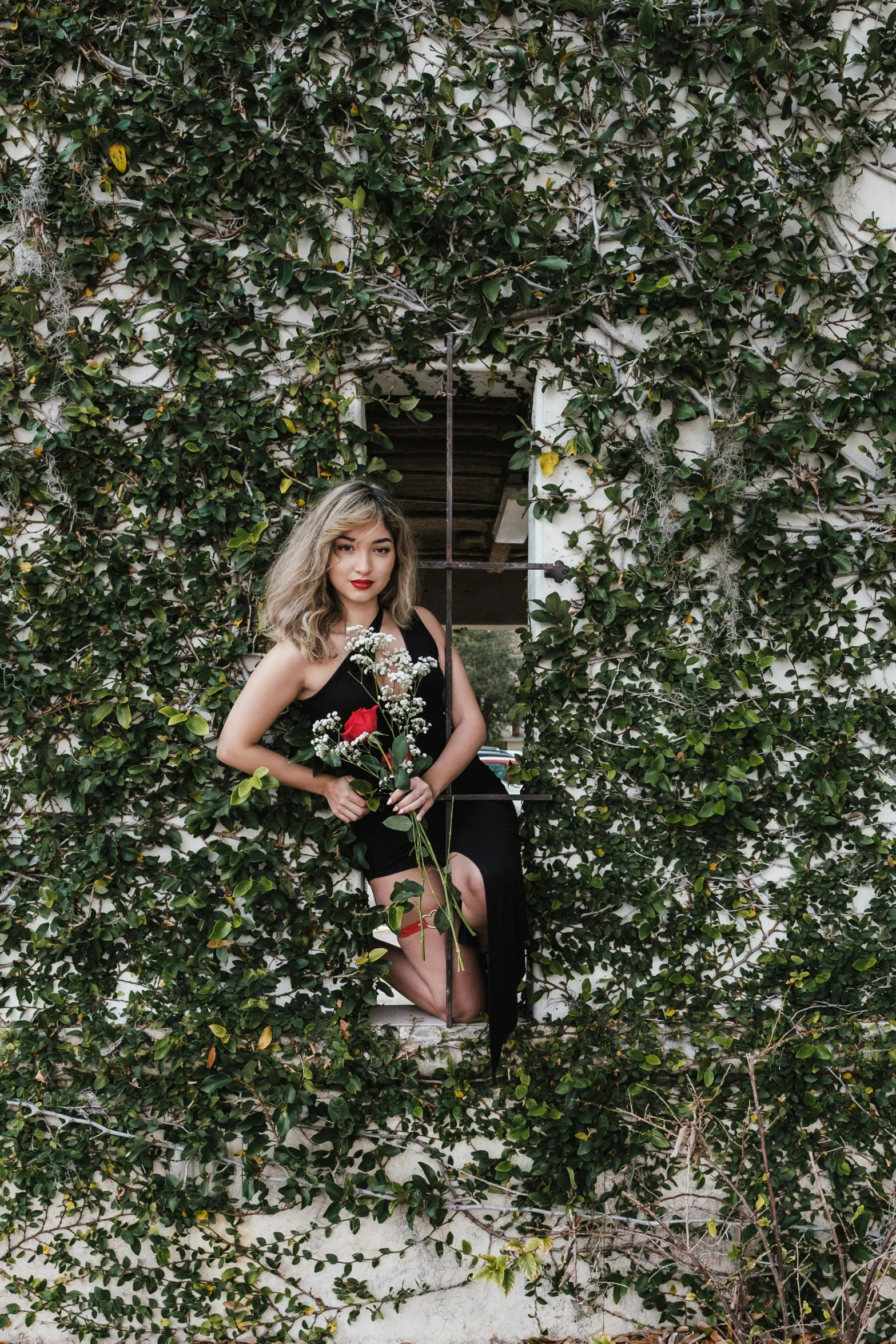 a woman in a black dress sitting on a window sill, an album cover, pexels contest winner, vines and flowers, sydney sweeney, vine covered, roses