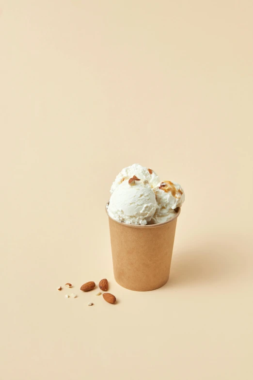 a cup of ice cream sitting on top of a table, product image, epicurious, sandy beige, frontal shot