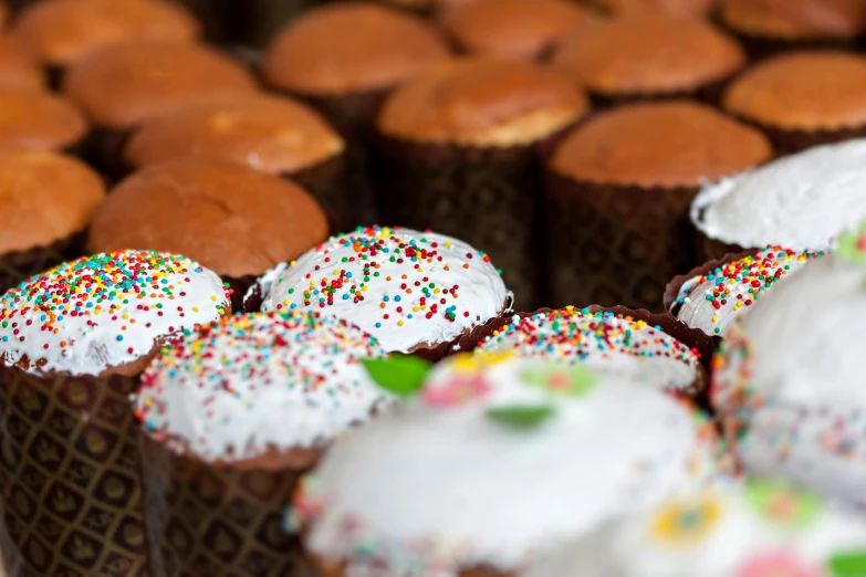 a bunch of cupcakes with white frosting and sprinkles, by Daniel Gelon, unsplash, renaissance, panorama, romanian, melbourne, kek