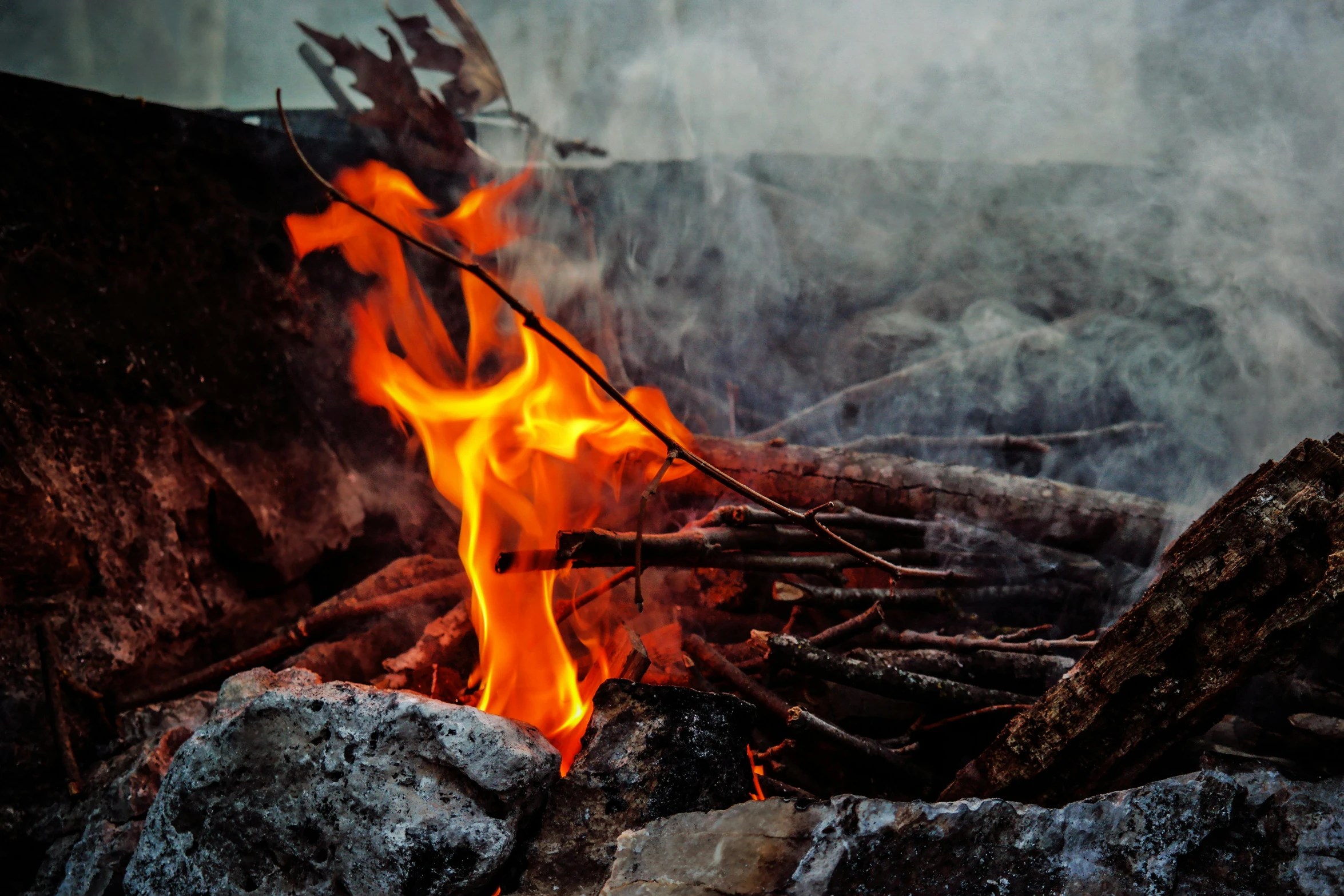 a fire in the middle of a pile of rocks, pexels contest winner, cooking it up, avatar image, smouldering charred timber, profile image