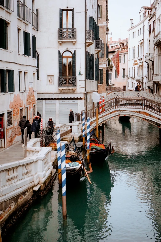 a couple of boats that are in the water, pexels contest winner, renaissance, all buildings on bridge, people walking around, gondola, shady alleys