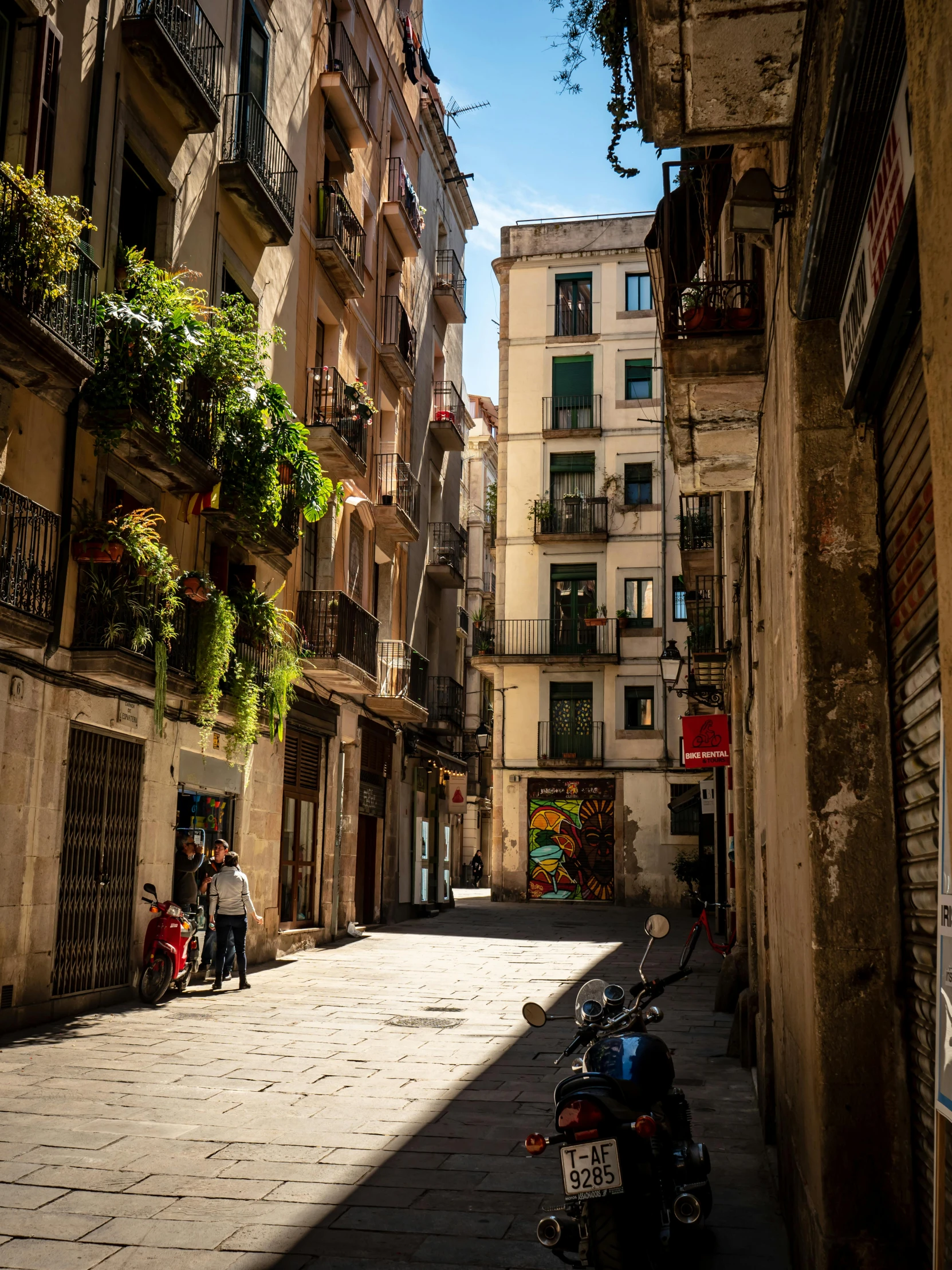 a couple of motorcycles parked on the side of a street, by Tom Wänerstrand, pexels contest winner, gothic quarter, dappled afternoon sunlight, colorful”, today\'s featured photograph 4k