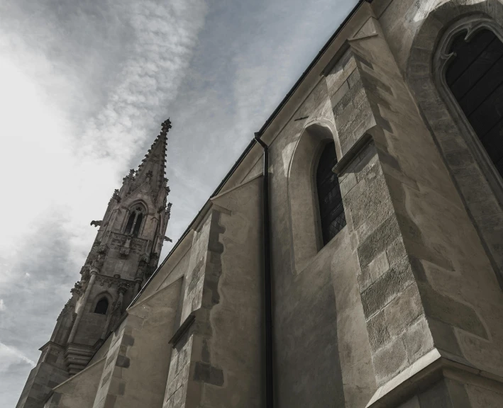 a very tall building with a clock on it's side, a photo, by Adam Szentpétery, pexels contest winner, baroque, shadow of catholic church cross, grey cloudy skies, split near the left, fine art print