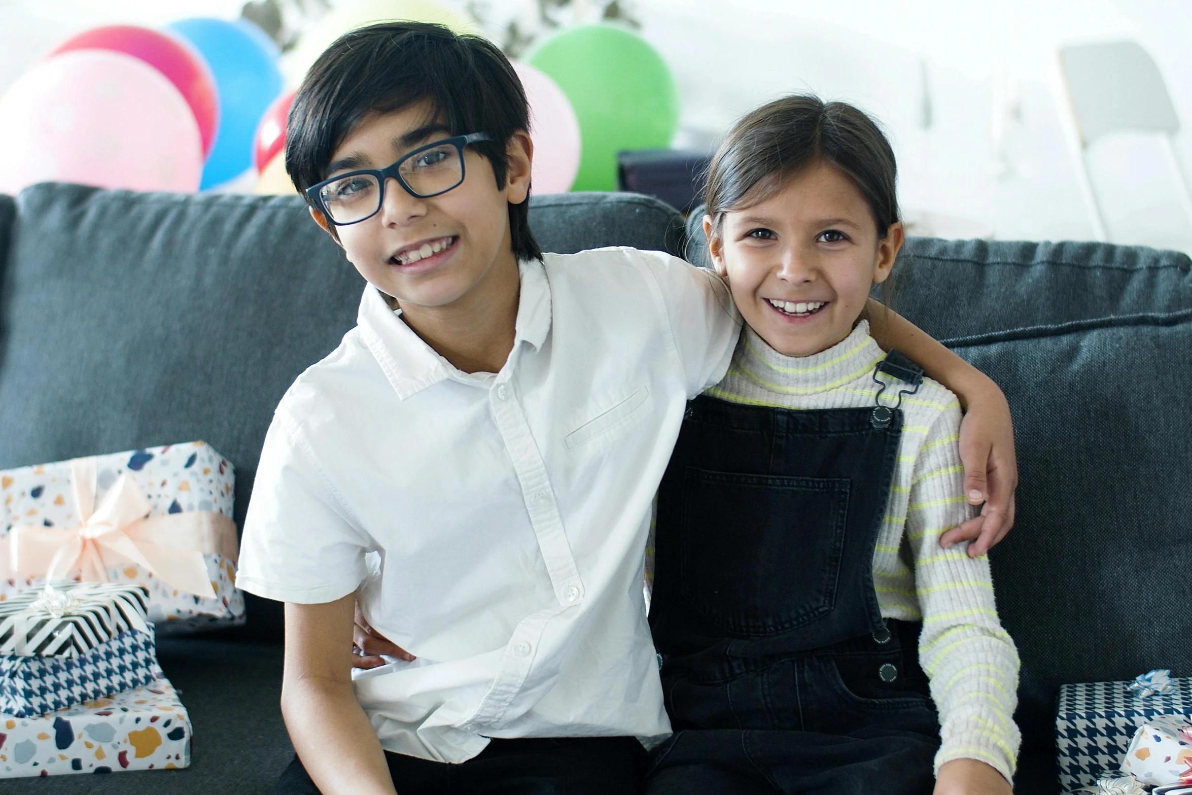 a couple of kids sitting on top of a couch, pexels contest winner, hurufiyya, at a birthday party, mia khalifa, promotional image, portrait image