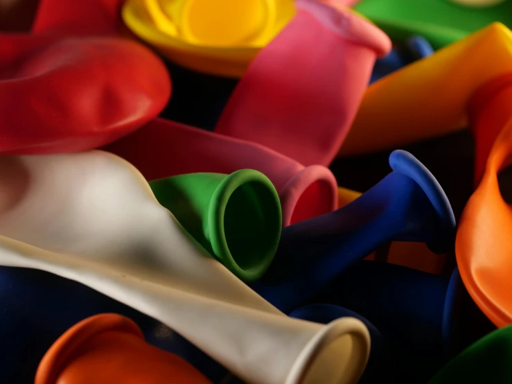 a pile of colorful golf tees sitting on top of each other, a still life, pexels, plasticien, party balloons, rubber hose animation, holding a balloon, valves