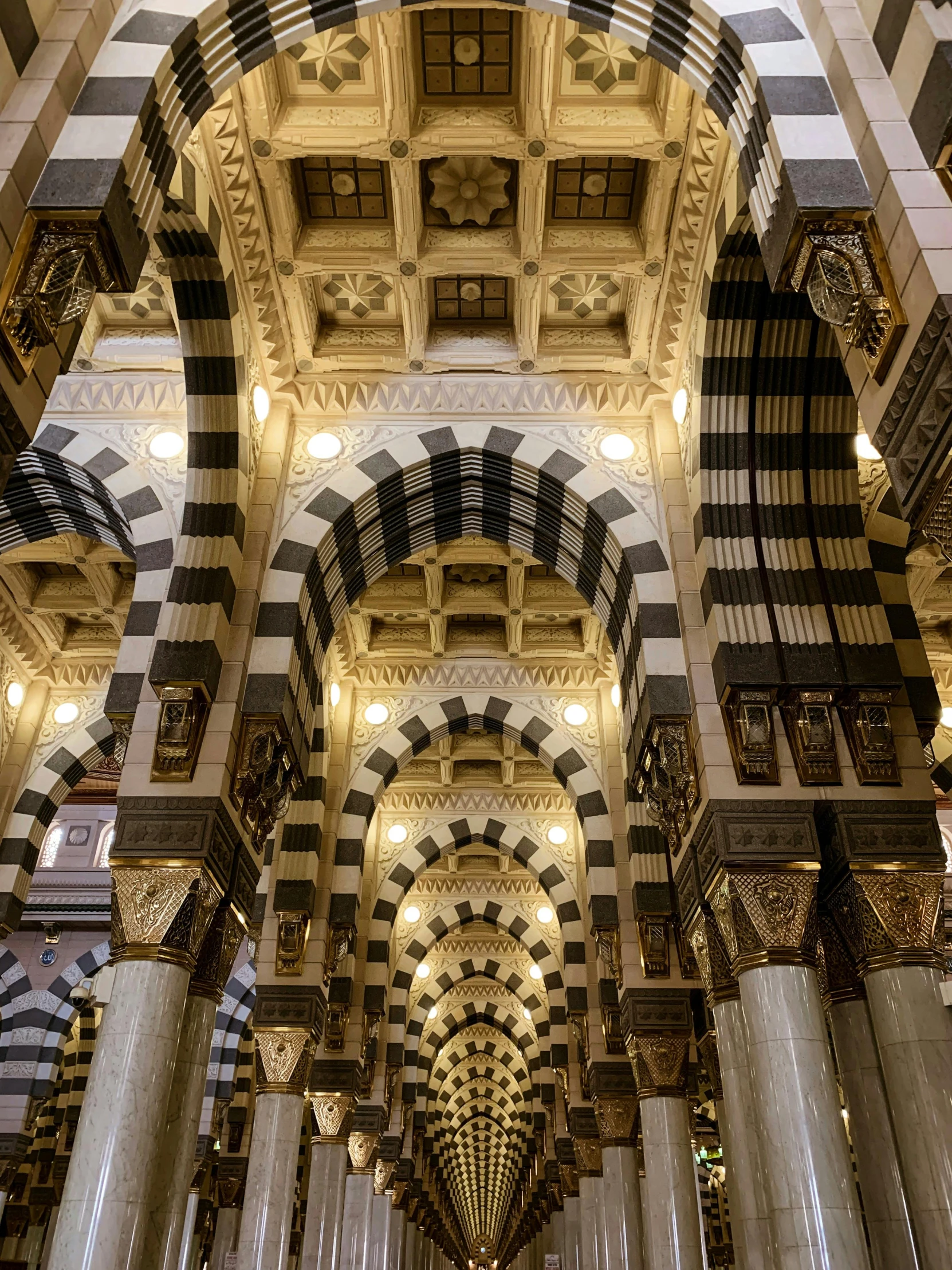 the inside of a building with columns and arches, a mosaic, inspired by Thomas Struth, pexels contest winner, arabesque, lit. 'honored ka'bah'), black domes and spires, grey, very sharp and detailed image