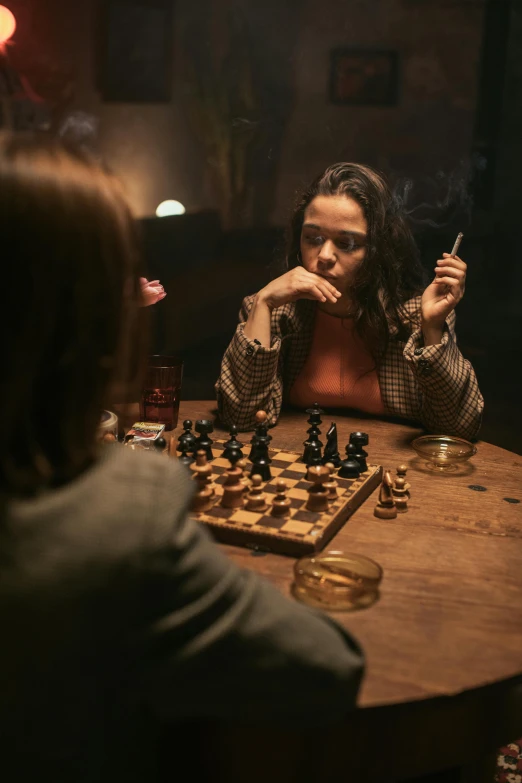 a group of people sitting around a table playing chess, a portrait, by Adam Marczyński, unsplash contest winner, woman smoking a cigarette, movie promotional image, on wooden table, promotional image