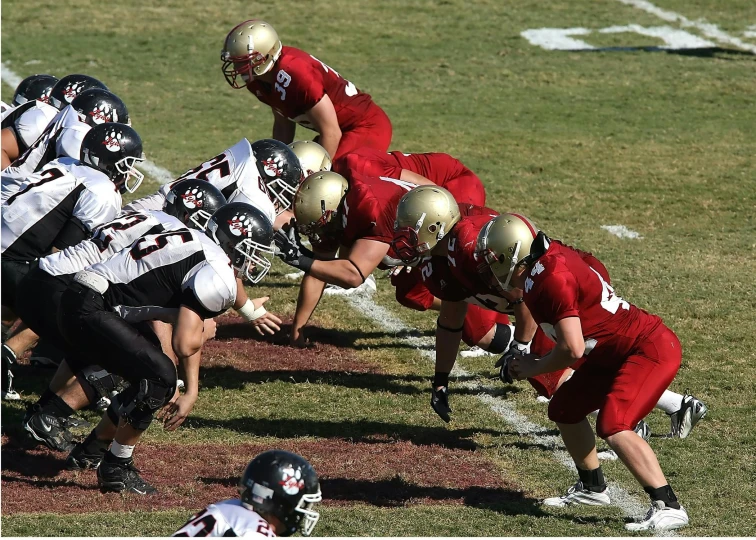 a group of young men playing a game of football, by Everett Warner, pexels, happening, gold and red metal, cranberry helmet, profile pic, military