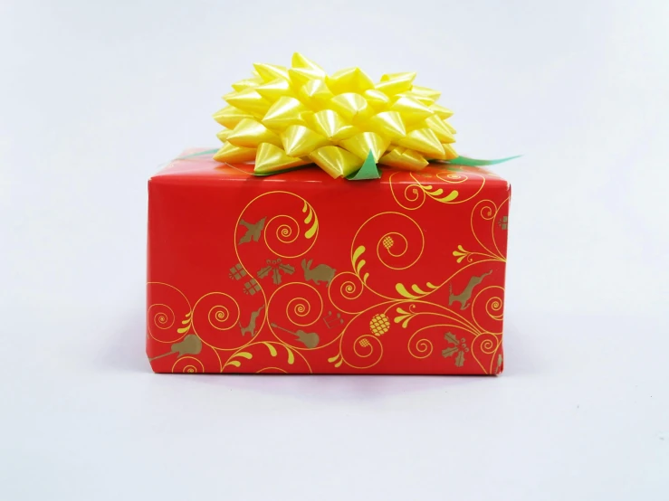 a red gift box with a yellow bow, red swirls, hair bow, napa, floral patterned skin