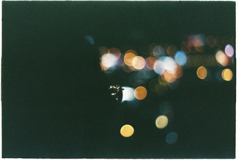 a close up of a fire hydrant with lights in the background, a polaroid photo, by Shigeru Aoki, boke, distant town lights, 1999 photograph, landing lights
