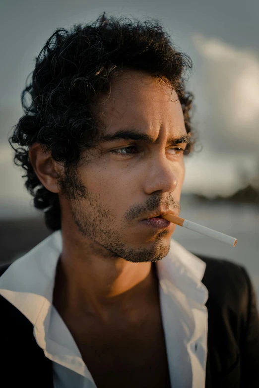 a man with a cigarette in his mouth, an album cover, inspired by Nan Goldin, unsplash, renaissance, robert sheehan, aboriginal australian hipster, on an island, profile image