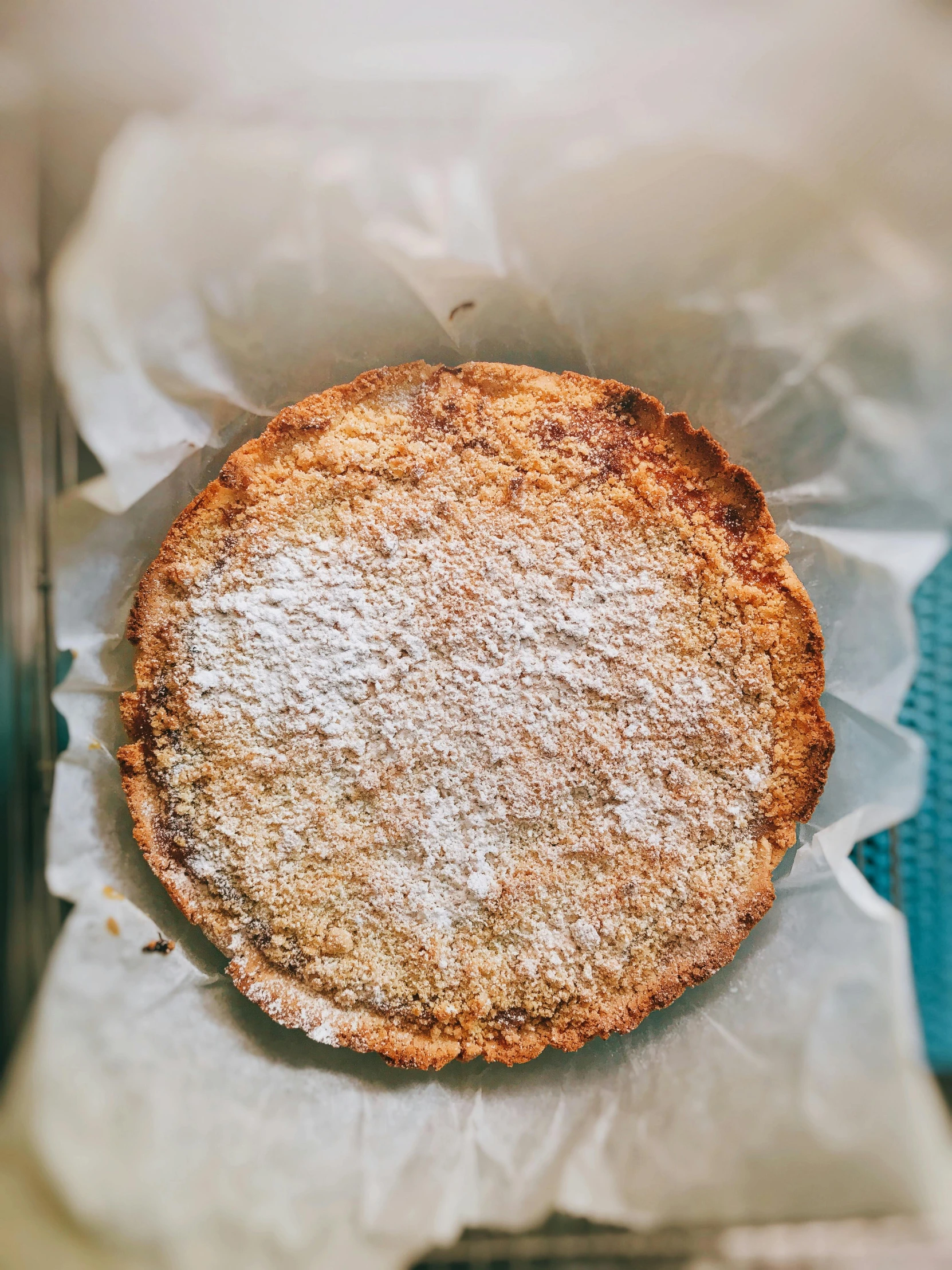 a pie sitting on top of a piece of wax paper, by Robbie Trevino, unsplash, powdered sugar, tall thin frame, 🎀 🧟 🍓 🧚, mexico