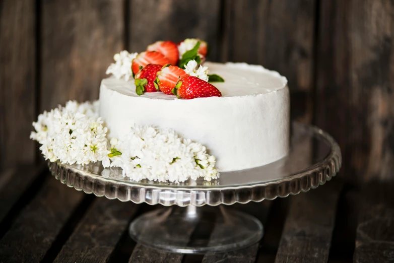 a white cake sitting on top of a glass cake plate, unsplash, strawberry, idyllic, vintage style, stainless steel