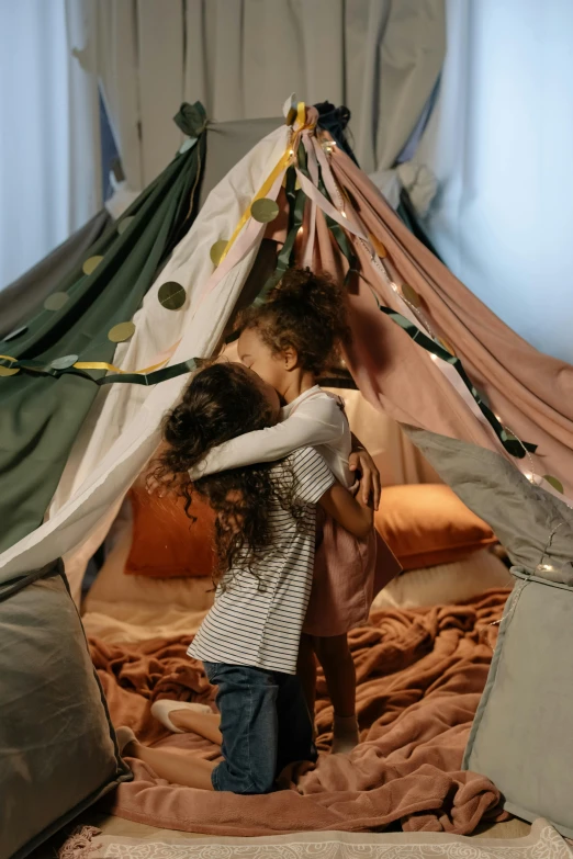 a little girl standing inside of a tent on top of a bed, hugging each other, kids playing, game ready, comforting