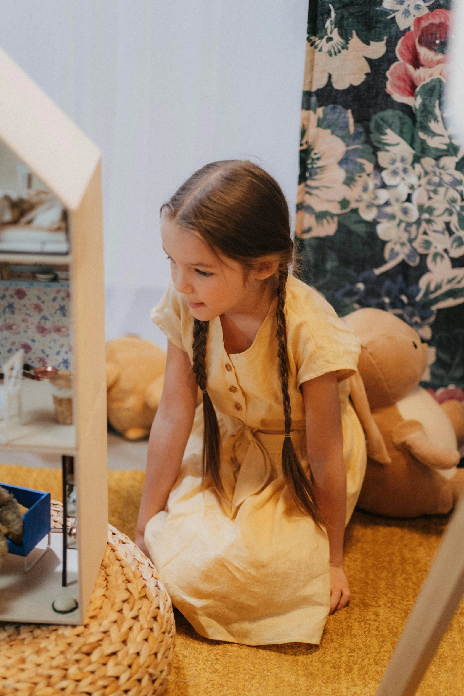 a little girl sitting on the floor in front of a doll house, inspired by Elsa Beskow, pexels contest winner, lady using yellow dress, live-action archival footage, detail shot, panoramic view of girl