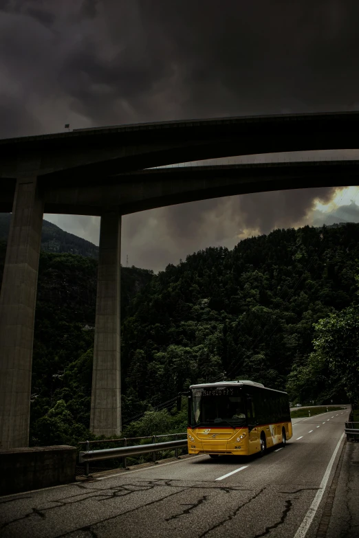 a bus that is sitting on the side of a road, a matte painting, inspired by Otto Meyer-Amden, pexels contest winner, under bridge, ominous! landscape of north bend, swiss modernizm, july 2 0 1 1