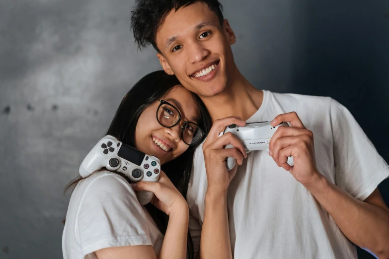 a man and a woman holding a video game controller, pexels contest winner, hyperrealism, asian descent, avatar image, teenagers, slight nerdy awkward smile