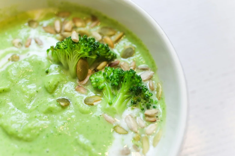 a close up of a bowl of soup with broccoli, a portrait, by Nicolette Macnamara, unsplash, hurufiyya, seafoam green, white, multi-part, salad