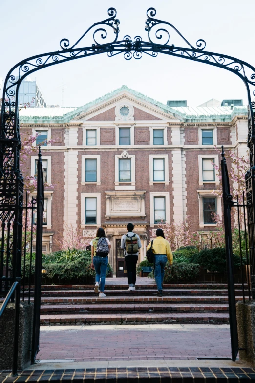 a group of people standing in front of a building, wrought iron architecture, college, boston, instagram picture