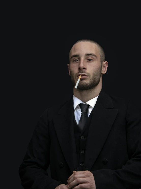 a man in a suit smoking a cigarette, an album cover, inspired by Nicola Samori, pexels contest winner, mac miller, headshot profile picture, taken in the late 2010s, herzog de meuron