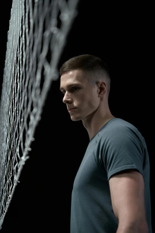 a man standing in front of a net holding a tennis racquet, trending on reddit, hyperrealism, crew cut hair, eve online movie still, vitalik buterin, 7 0 mm. dramatic lighting