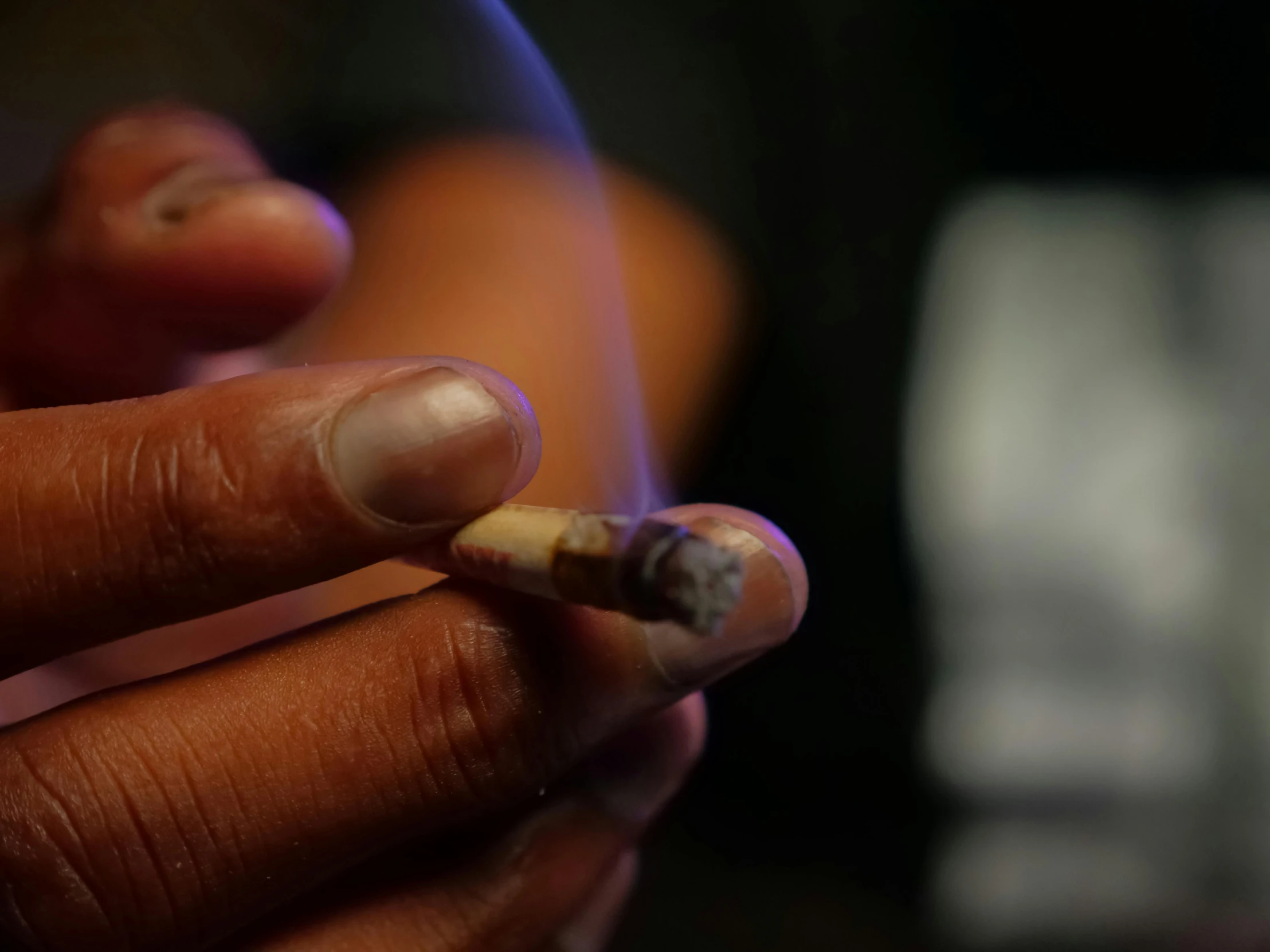 a close up of a person holding a cigarette, lit up in a dark room, high times, slide show, animation