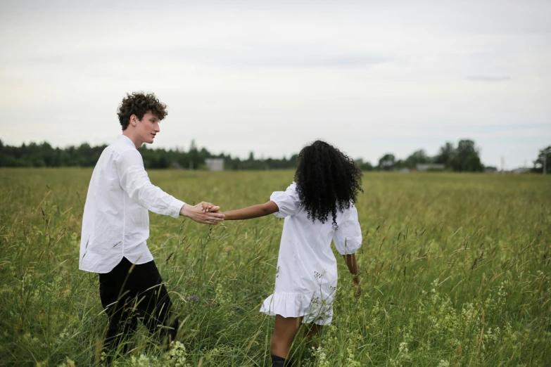 a man and a woman holding hands in a field, an album cover, by Zofia Stryjenska, pexels contest winner, renaissance, with afro, white, sza, programming