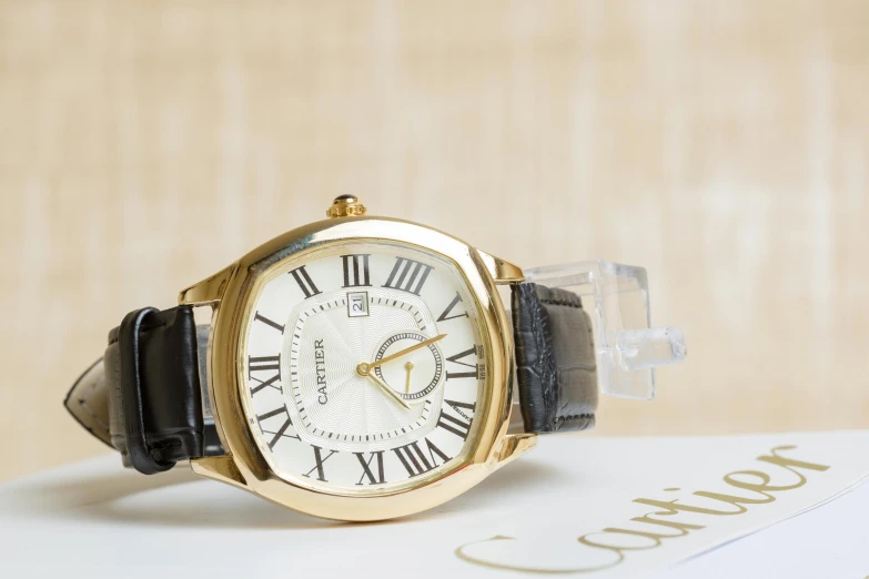 a close up of a wrist watch with roman numerals, an album cover, inspired by Eugène Brands, unsplash, arabesque, relaxed. gold background, calvin klein photograph, square, ebay listing thumbnail