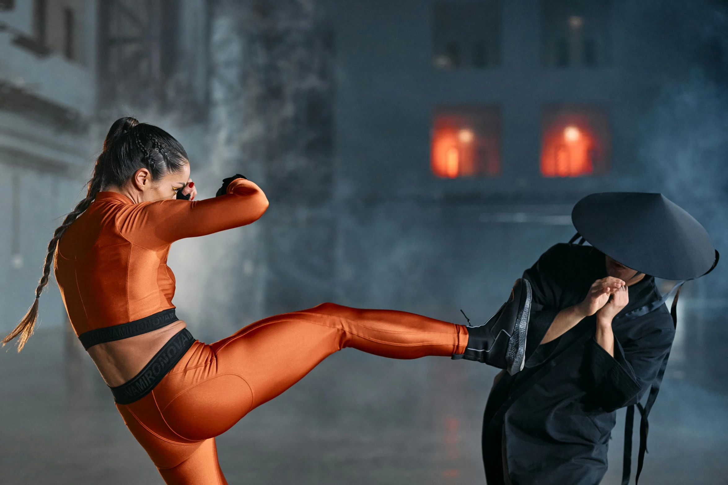 a woman kicking a man with an umbrella, a digital rendering, pexels contest winner, arabesque, two piece workout clothes, in orange clothes) fight, ninja outfit, 2019 trending photo