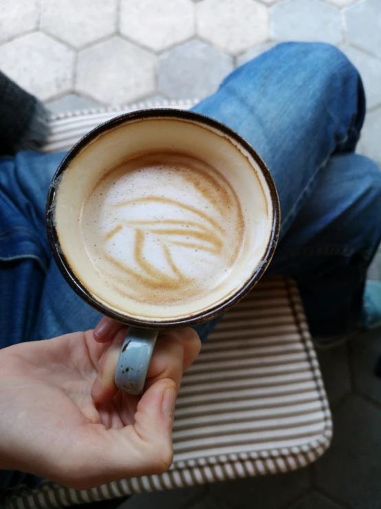 a close up of a person holding a cup of coffee, profile image, top down, vanilla, thumbnail