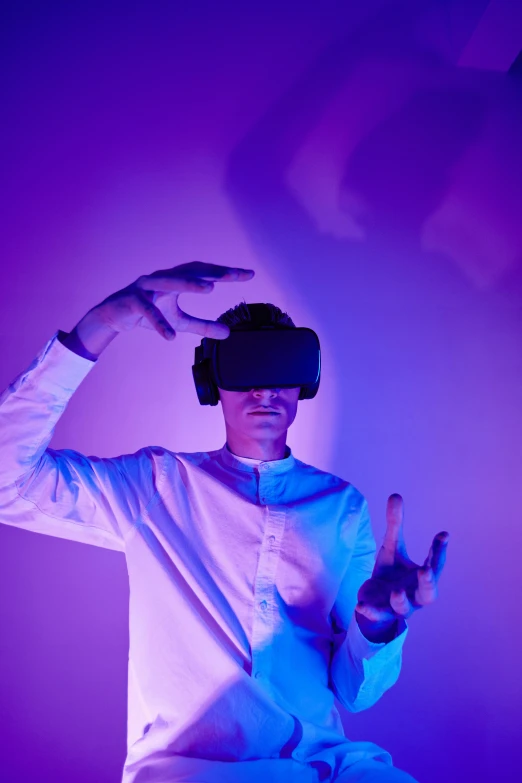 a man in a white shirt wearing a virtual reality headset, a hologram, unsplash, interactive art, purple, triumphant pose, college, vantablack cloth technology