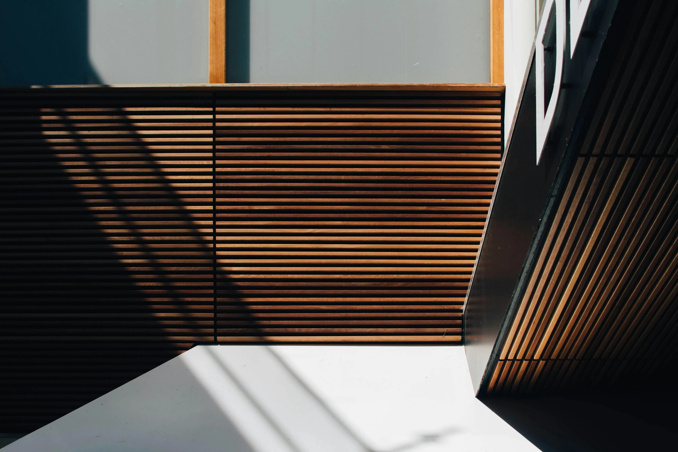 a white bed sitting under a window next to a wooden slatt, inspired by Donald Judd, trending on unsplash, penrose stairs, consist of shadow, iron cladding, high-angle